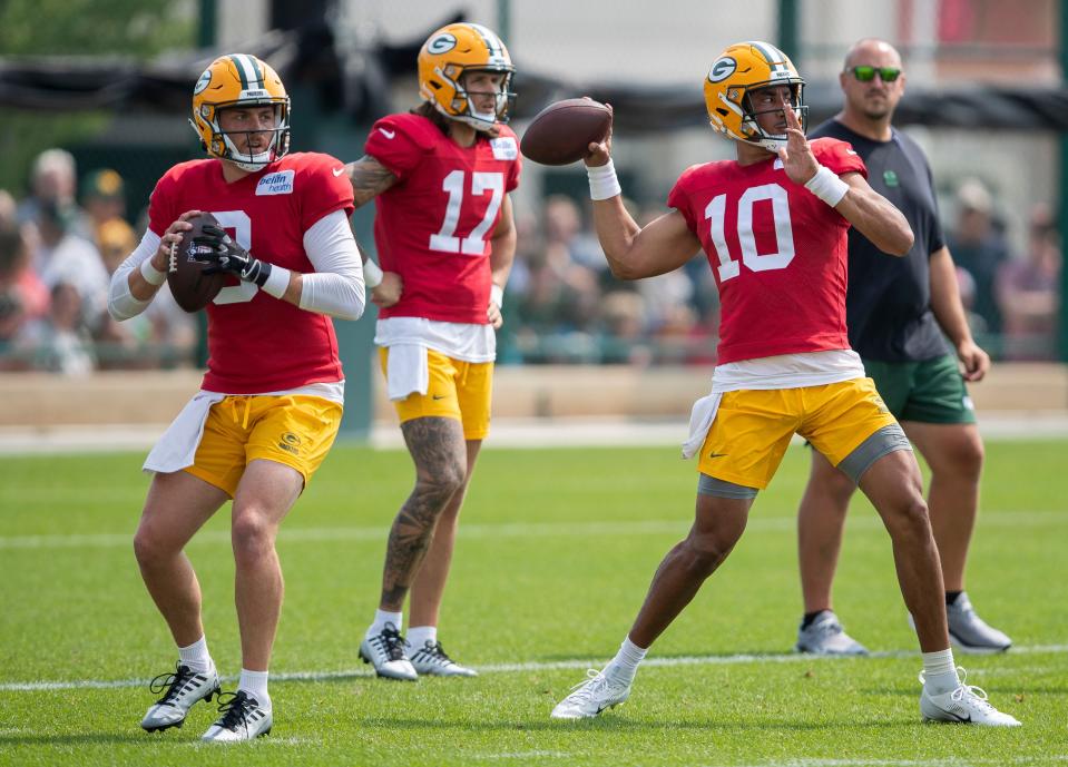 Green Bay Packers quarterbacks <a class="link " href="https://sports.yahoo.com/nfl/players/40173" data-i13n="sec:content-canvas;subsec:anchor_text;elm:context_link" data-ylk="slk:Sean Clifford;sec:content-canvas;subsec:anchor_text;elm:context_link;itc:0">Sean Clifford</a> (8) and <a class="link " href="https://sports.yahoo.com/nfl/players/32696" data-i13n="sec:content-canvas;subsec:anchor_text;elm:context_link" data-ylk="slk:Jordan Love;sec:content-canvas;subsec:anchor_text;elm:context_link;itc:0">Jordan Love</a> (10) throw passes during practice on Monday, July 31, 2023, at Ray Nitschke Field in Green Bay, Wis.