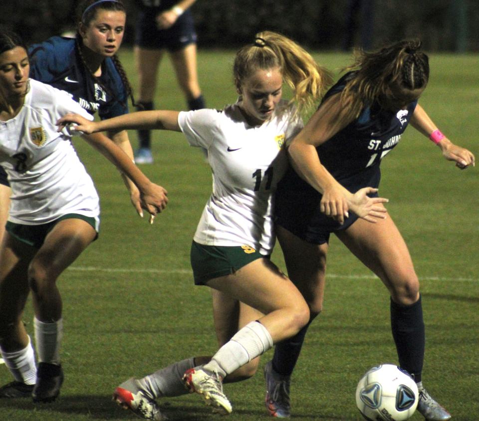 St. Johns Country Day midfielder Kamryn Towers (15) attempts to hold off a tackle from Shorecrest Prep fullback Payton Thompson (11) during Wednesday's Class 2A final.