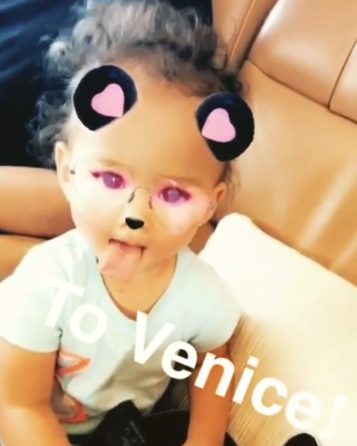 <p>Luna Legend isn’t even 2, but she knows how to work a Snapchat filter. What else are you supposed to do en route to Venice? (Photo: Chrissy Teigen via Instagram) </p>