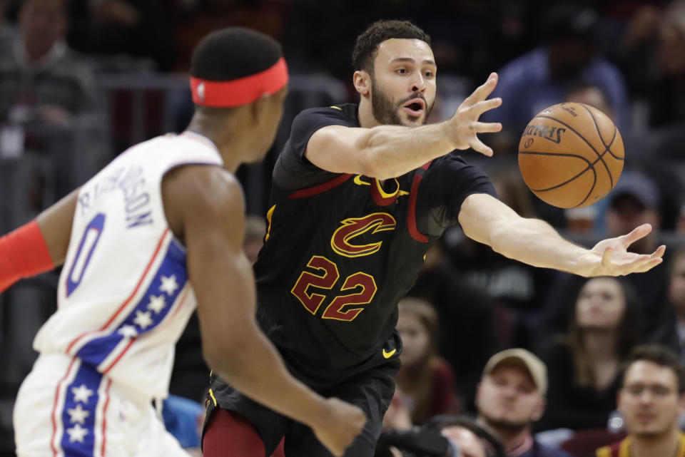 Cleveland Cavaliers' Larry Nance Jr. (22) grabs a rebound ahead of Philadelphia 76ers' Josh Richardson (0) in the second half of an NBA basketball game, Wednesday, Feb. 26, 2020, in Cleveland. The Cavaliers won 108-94. (AP Photo/Tony Dejak)