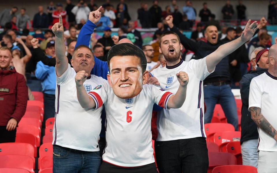 LONDON, ENGLAND - JUNE 18: An England fan wearing a large Harry Maguire face mask show their support prior to the UEFA Euro 2020 Championship Group D match between England and Scotland at Wembley Stadium on June 18, 2021 in London, England. (Photo by Andy Rain - Pool/Getty Images)  - Andy Rain/Pool/Getty Images