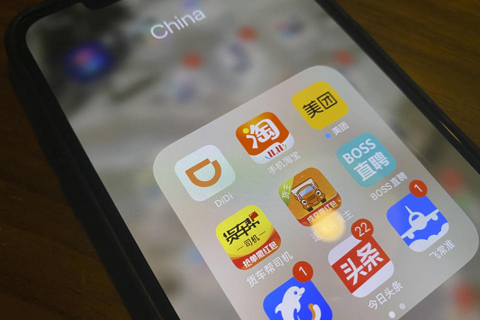 The ride-hailing app Didi is seen near other Chinese apps on a phone in Beijing on Monday, July 5, 2021. Chinese regulators have clamped down on the country’s largest ride-hailing app, Didi Global Inc., days after its shares began trading in New York. Authorities told Didi to stop new registrations and ordered its app removed from China’s app stores pending a cybersecurity review. (AP Photo/Ng Han Guan)