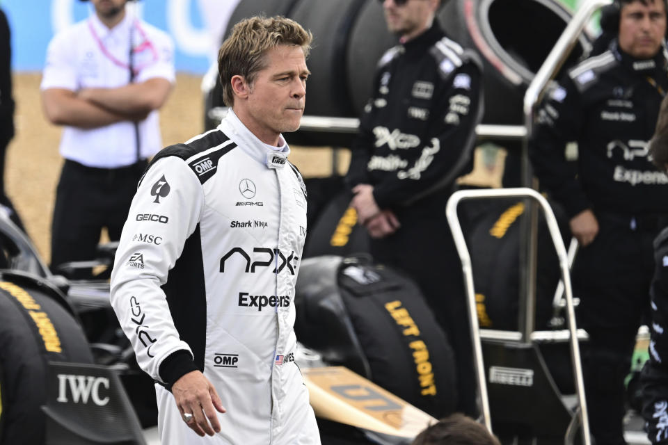 FILE - Actor Brad Pitt walks through the paddock before the British Formula One Grand Prix race at the Silverstone racetrack, Silverstone, England, on July 9, 2023. Brad Pitt's Hollywood film about Formula 1 is being released in cinemas next June and will simply be called “F1,” the racing series said on Friday, Friday, July 5, 2024. (Christian Bruna/Pool Photo via AP, File)