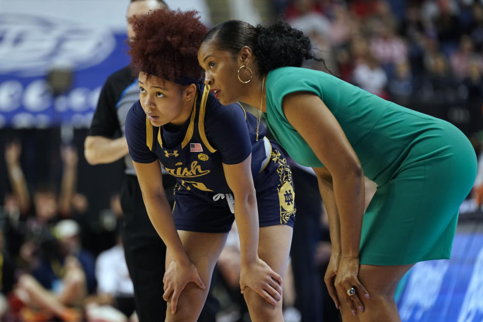 Notre Dame head coach Niele Ivey, right, talks with Hannah Hidalgo, left, during the first half against NC State in an NCAA basketball game for the Women's Atlantic Coast Conference championship in Greensboro, N.C., Sunday, March 10, 2024. (AP Photo/Chuck Burton)