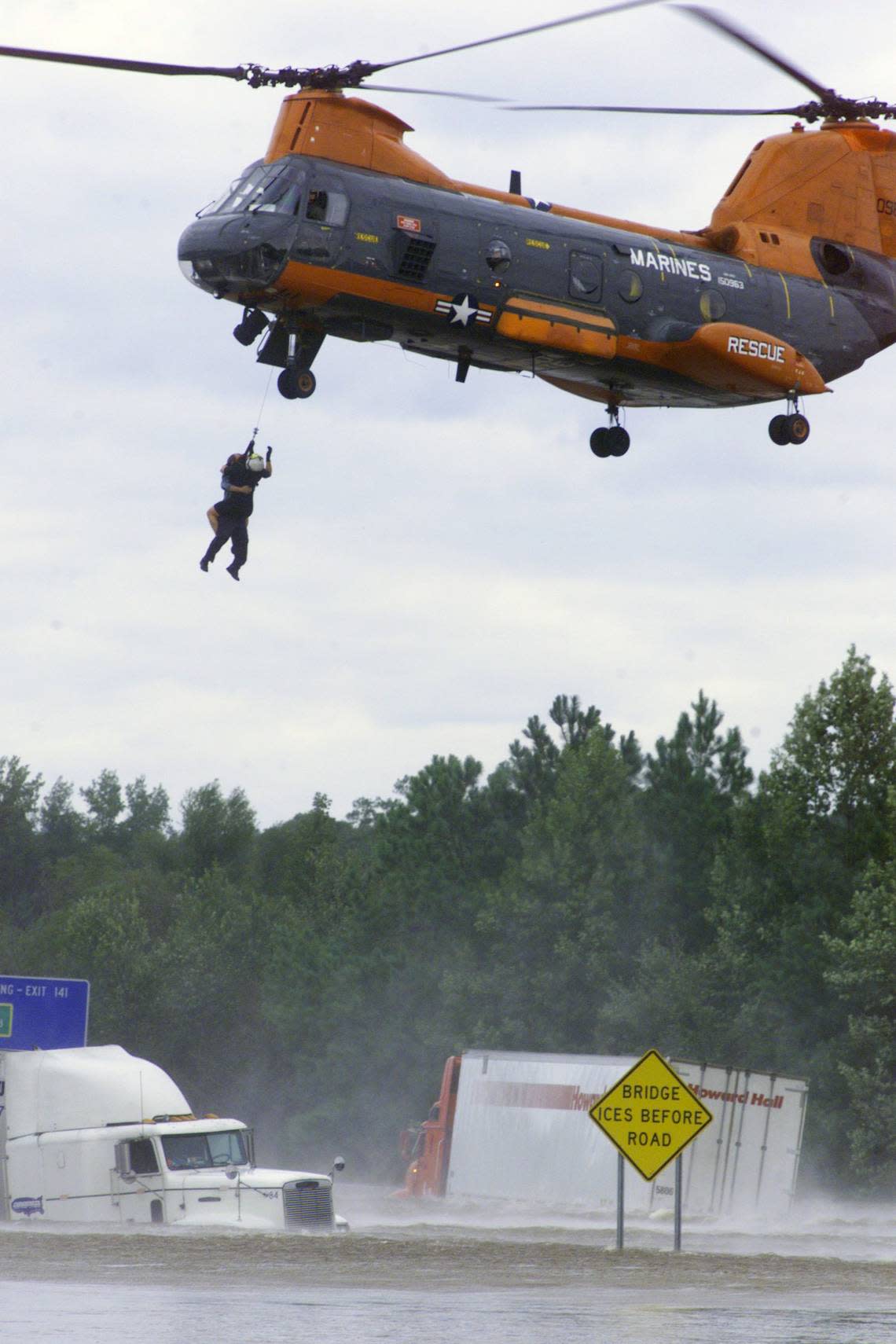 A helicopter rescues truck driver James Hammond, of Bridgeport, N.J.. from his flooded rig on Interstate 95 near Rocky Mount after his rig floated off the roadway after Hurricane Floyd.