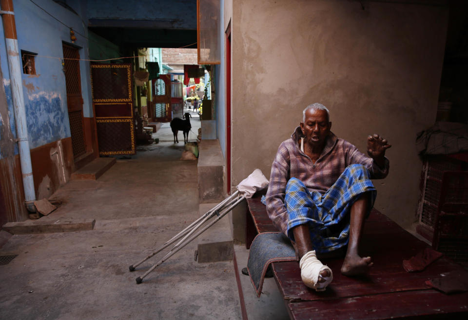 In this Feb. 5, 2014 photo, Leprosy-affected Jaffar Ali, 75, makes an effort to get up from his cot outside his house at a leper colony in New Delhi, India. Although India has made great strides against leprosy over the years, the stigma of the disease is as intractable as ever, hindering efforts to eliminate the disease entirely. Worldwide the number of new leprosy patients has dropped from around 10 million in 1991 to around 230,000 last year. Of these, 58 percent were to be found in India, according to the World Health Organization. (AP Photo/Manish Swarup)