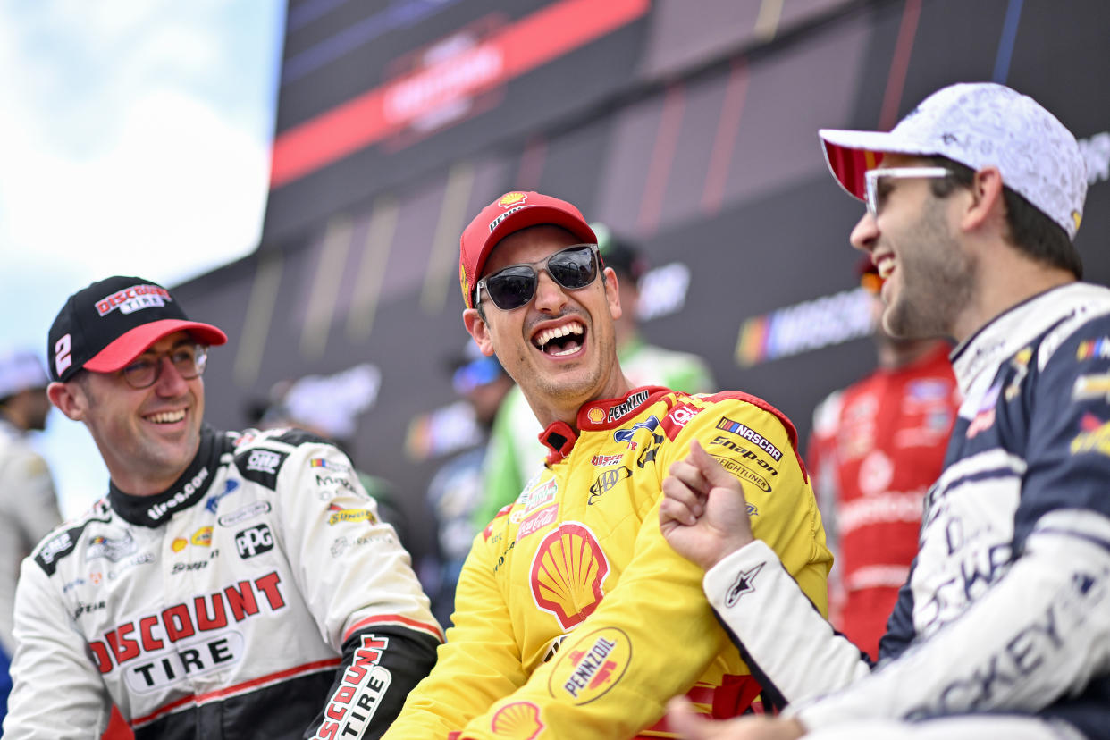 BROOKLYN, MICHIGAN - AUGUST 18: (L-R) Austin Cindric, driver of the #2 Discount Tire Ford, Joey Logano, driver of the #22 Shell Pennzoil Ford, and Daniel Suarez, driver of the #99 Jockey Infinite Cool Underwear Chevrolet, share a laugh backstage during pre-race ceremonies prior to the NASCAR Cup Series FireKeepers Casino 400 at Michigan International Speedway on August 18, 2024 in Brooklyn, Michigan. (Photo by Logan Riely/Getty Images)