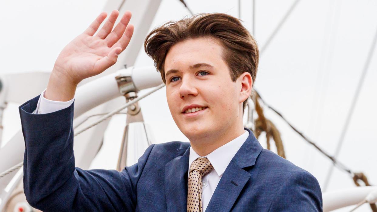 Crown Prince Christian waving from a boat