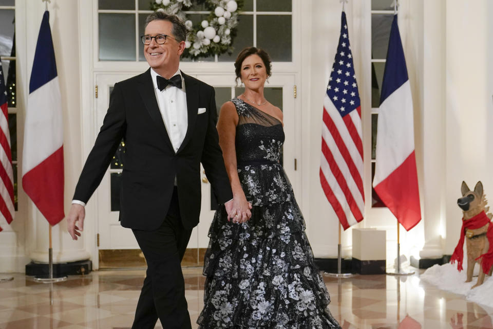 Late night talk show host Stephen Colbert and his wife Evelyn McGee-Colbert arrive for the State Dinner with President Joe Biden and French President Emmanuel Macron at the White House in Washington, Thursday, Dec. 1, 2022. (AP Photo/Susan Walsh)