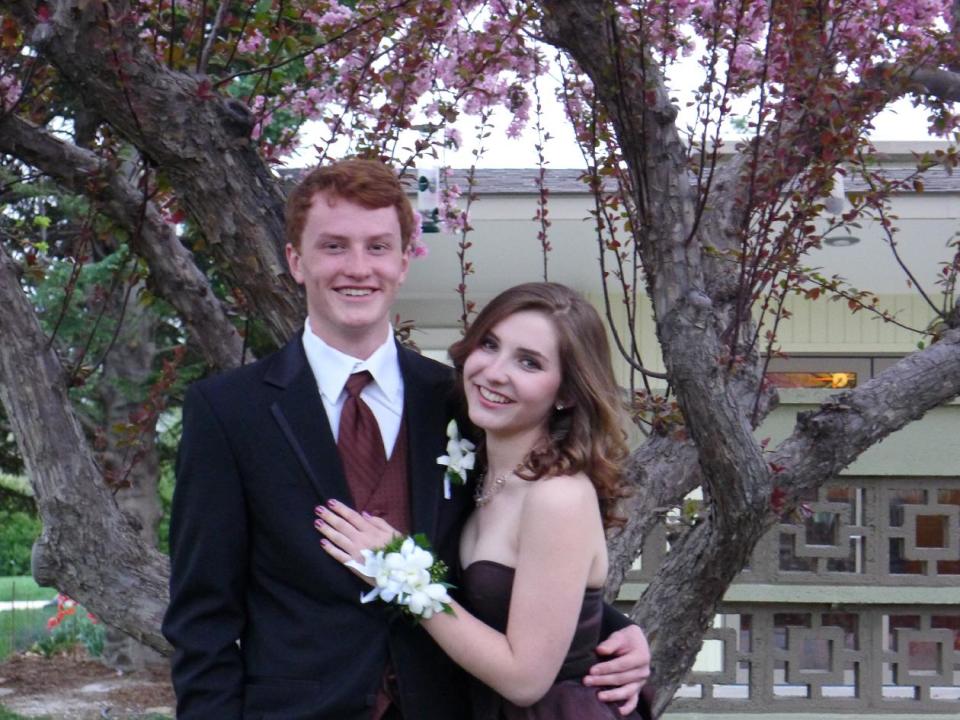 This April 2012 photo released by Patricia Weintraub shows Amy Weintraub, right, and Luke Siddens posing for a picture for the Poudre High School prom in Fort Collins, Colo. Luke used a cell phone photo of Amy's dress to make sure his tie was in a matching shade of brown. (AP Photo/Patricia Weintraub)