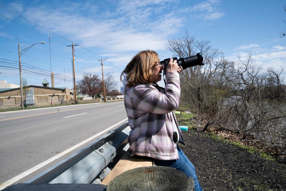 Joanne Miller smiles Monday as she photographs a nest of bald eagles from alongside Dublin Road.