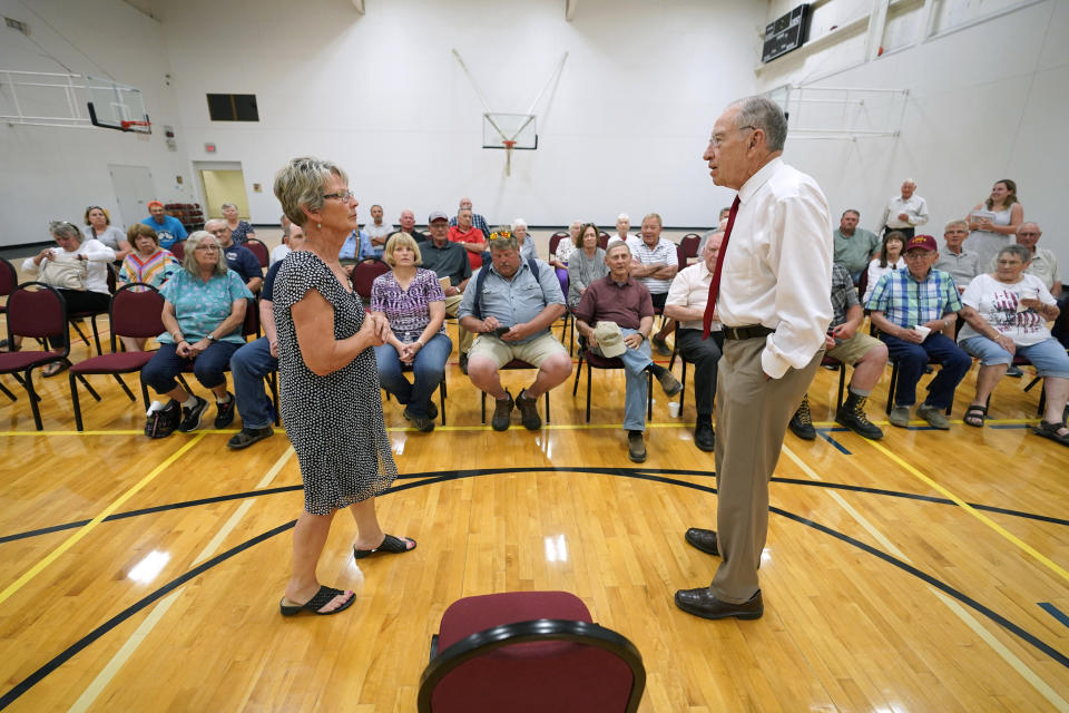 In this June 30, 2021, photo Sen. Chuck Grassley, R-Iowa, talks with Teresa Paulsrud, of Danbury, Iowa, left, during a town hall meeting in Ida Grove, Iowa. (AP Photo/Charlie Neibergall)