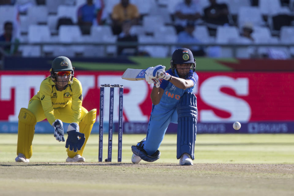 India's Harmanpreet Kaur makes a shot while Australia's Alyssa Healy looks on during the Women's T20 World Cup semi final cricket match in Cape Town, South Africa, Thursday Feb. 23, 2023. (AP Photo/Halden Krog)