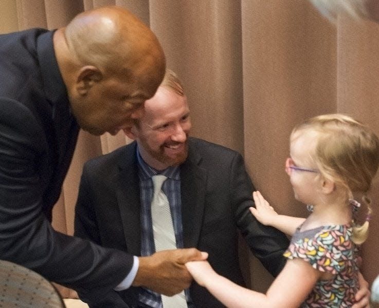 U.S. Rep. John Lewis greets Harper Powell with her dad, Nate, at a 2015 reception prior to speaking at the IU Auditorium as part of a series on “The Power of Words.” (David Snodgress / Herald-Times)