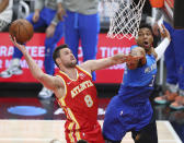 Atlanta Hawks forward Danilo Gallinari goes to the basket for a slam against Milwaukee Bucks forward Giannis Antetokounmpo during the second quarter of Game 3 of the NBA Eastern Conference basketball finals, Sunday, June 27, 2021, in Atlanta. (Curtis Compton/Atlanta Journal-Constitution via AP)