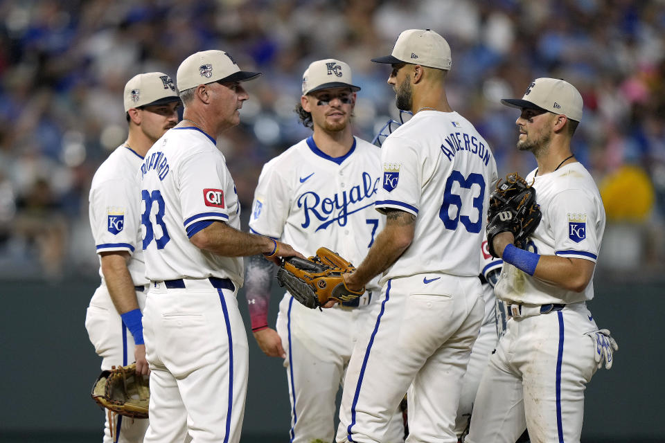 Kansas City Royals manager Matt Quatraro (33) talks to his team during a pitching change in the sixth inning of a baseball game against the Tampa Bay Rays Thursday, July 4, 2024, in Kansas City, Mo. (AP Photo/Charlie Riedel)