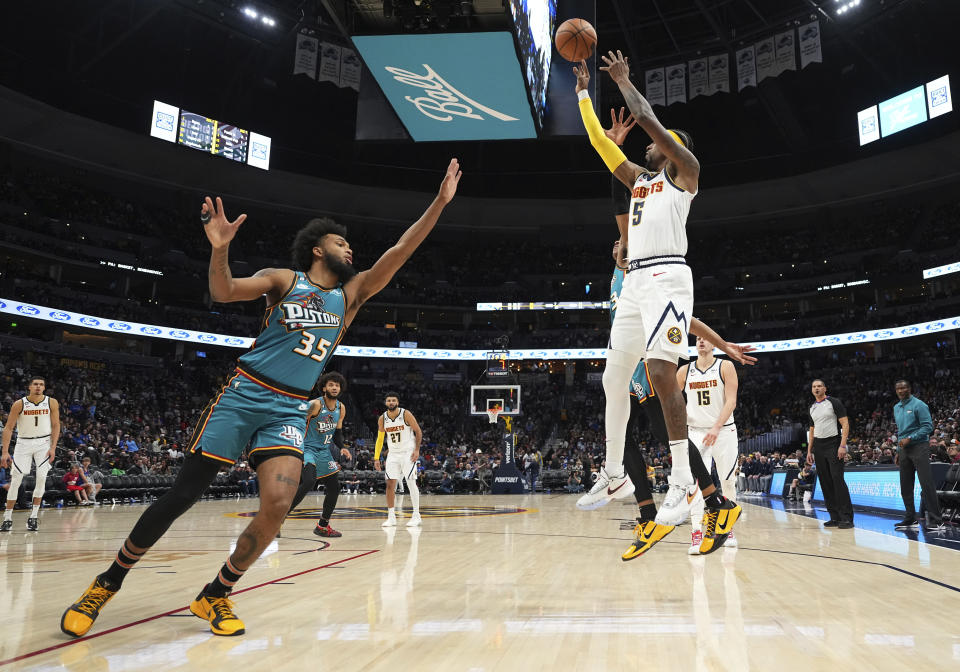 Denver Nuggets guard Kentavious Caldwell-Pope (5) shoots against Detroit Pistons forward Marvin Bagley III (35) during the third quarter of an NBA basketball game, Tuesday, Nov. 22, 2022, in Denver. (AP Photo/Jack Dempsey)