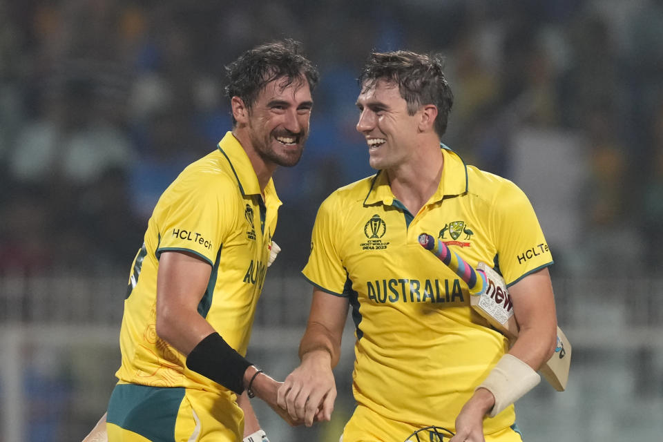 Australia's captain Pat Cummins and Mitchell Starc celebrate their win in the ICC Men's Cricket World Cup second semifinal match with South Africa in Kolkata, India, Thursday, Nov. 16, 2023. (AP Photo/Bikas Das)