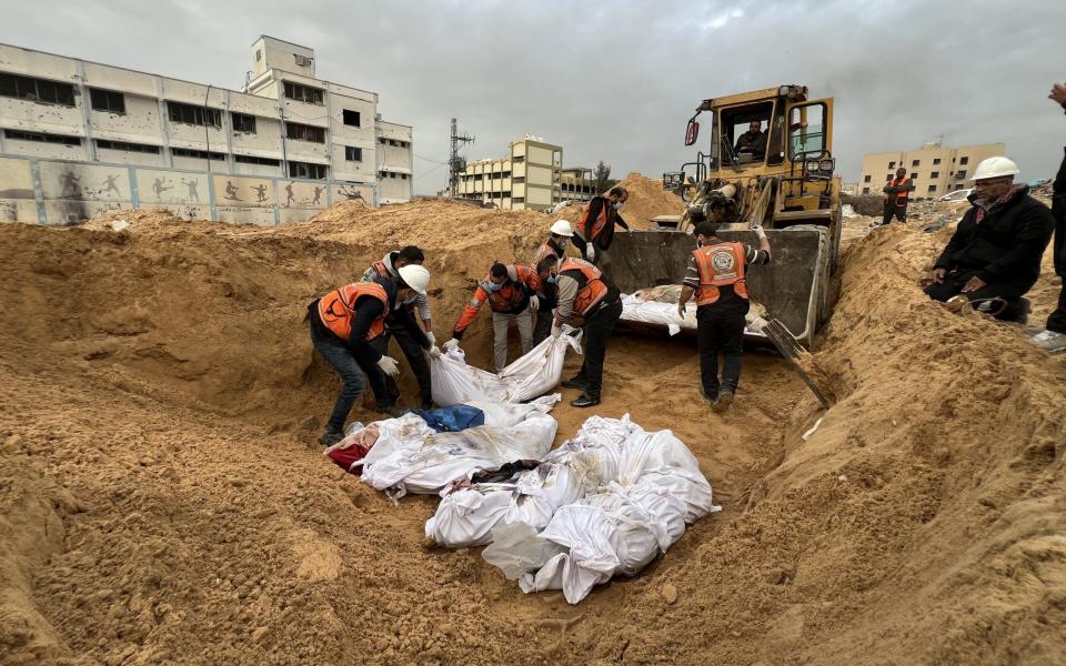 Palestinians killed in Israeli attacks are buried in a mass grave as some cemeteries run out of space due to the rising death toll as Israeli attacks continue in Gaza City, Gaza on December 23, 2023.