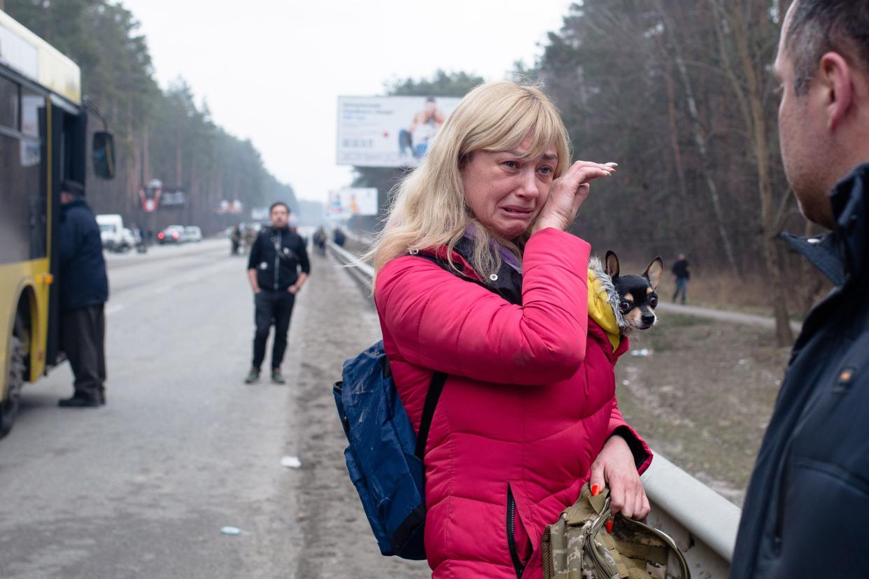 A wife says her goodbyes to her husband who is a member of the Territorial Defense as she evacuates from the city on March 6, 2022, near Irpin, Ukraine.