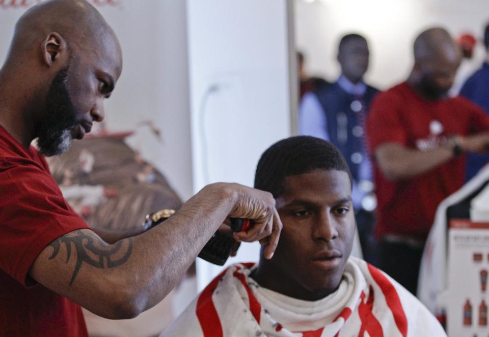 This May 6, 2014 photo shows NFL Draft prospect Kony Ealy, a defensive end from Missouri, getting a haircut during the 5th Annual NFL Pre-Draft Gifting & Style Suite at the Sean John showroom in New York. Ealy is among dozens of prospects on the National Football League's annual draft, with 32 players per round and seven rounds, beginning Thursday night at Radio City. Ealy is projected to go late in the first round. (AP Photo/Frank Franklin II)