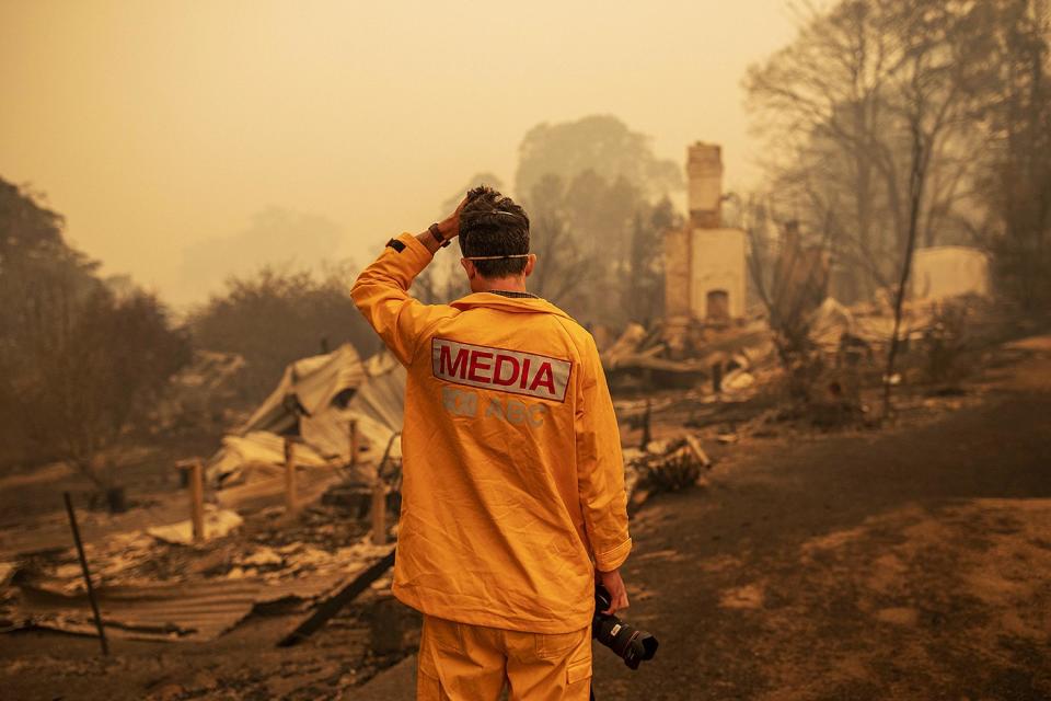 ABC photographer Matt Roberts reacts to seeing his sister's house destroyed by a bushfire in Quaama, New South Wales, Australia, on Jan. 1. 
