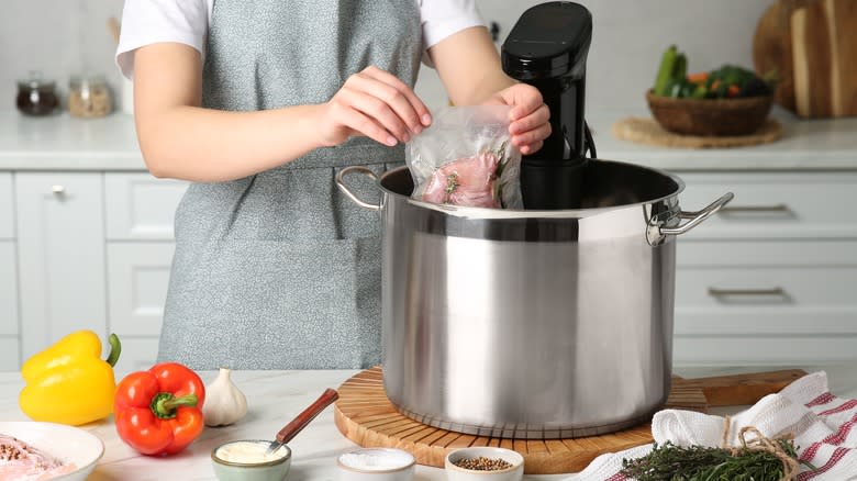 Putting vacuum-sealed meat into a precision cooker