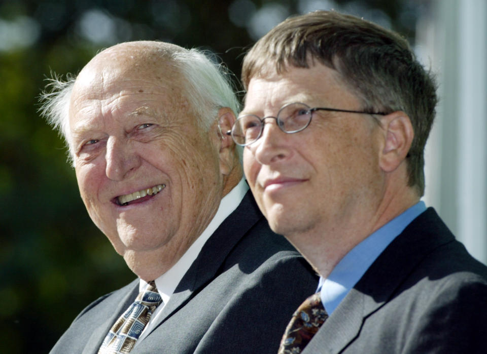 FILE - In this Sept. 12, 2003 file photo, William H. Gates Sr., left, smiles while sitting next to his son, Bill Gates Jr., during the dedication and grand opening of the William H. Gates Hall, new home of the University of Washington School of Law in Seattle. Bill Gates Sr., a lawyer and philanthropist and father of Microsoft co-founder Bill Gates, died Monday, Sept. 14, 2020, at age 94. (AP Photo/John Froschauer, File)