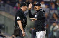 New York Yankees manager Aaron Boone talks to umpire Lance Barrett (16) during the second inning of the team's baseball game against the Toronto Blue Jays, Wednesday, Sept. 20, 2023, in New York. (AP Photo/Noah K. Murray)