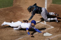 Chicago Cubs' Willson Contreras, bottom, is tagged out before reaching home by Miami Marlins catcher Chad Wallach (17) during the fourth inning in Game 2 of a National League wild-card baseball series Friday, Oct. 2, 2020, in Chicago. (AP Photo/Nam Y. Huh)