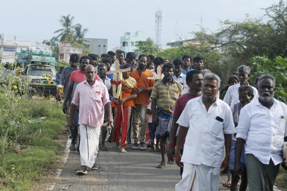 Relatives of a man, who died after drinking illegally brewed liquor, walk in a funeral procession for his burial in Kallakurichi district of the southern Indian state of Tamil Nadu, India, Thursday, June 20, 2024. The state's chief minister M K Stalin said the 34 died after consuming liquor that was tainted with methanol, according to the Press Trust of India news agency. (AP Photo/R. Parthibhan)