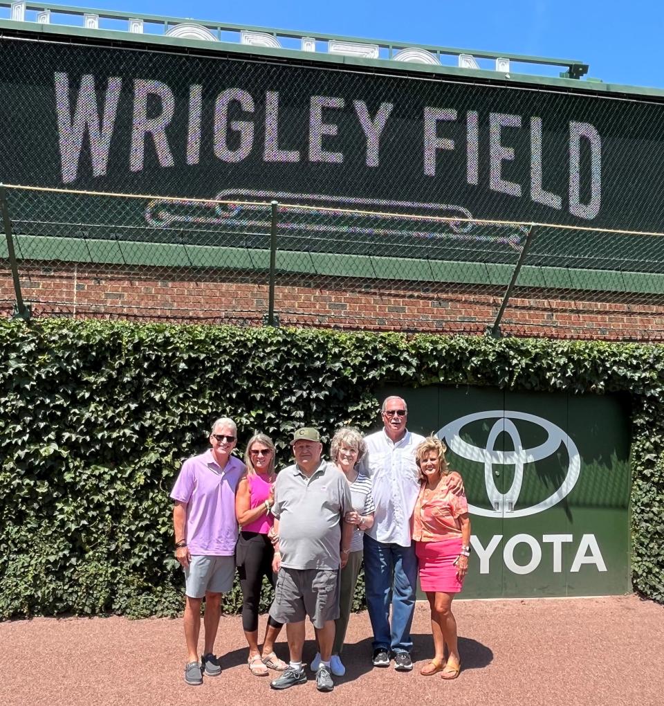 Democrat sports editor Jim Henry, left, with wife Dawn, David Ross, Jackie Ross, Charles Newlin and Kathy Newlin in front of the left-field ivy wall at Wrigley Field.