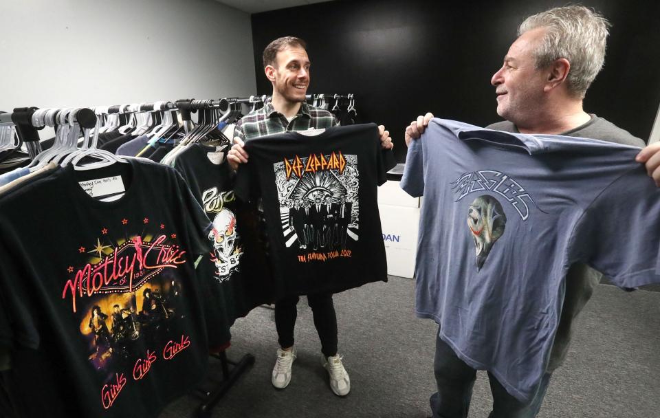 Joey Santo, left, and Stuart Miller hold some of the custom t-shirts their company produced for touring bands at Culture Studio's new Daytona Beach custom apparel manufacturing plant on Thursday, Jan. 5, 2023. Santo is the company's chief operating officer. Miller oversees the new plant as director of southern production.