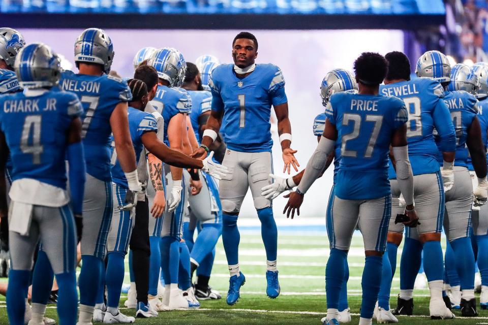 Detroit Lions cornerback Jeff Okudah (1) high-fives teammates during player introduction before Washington Commanders game at Ford Field, Sept. 18, 2022.
