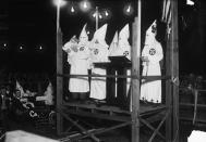 <p>Closeup of speaker’s stand surrounded by hooded Klansmen during Long Island rally. (Photo: Getty Images </p>
