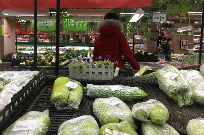 Customers are seen at the vegetable section of a supermarket in Wuhan, the epicentre of the novel coronavirus outbreak