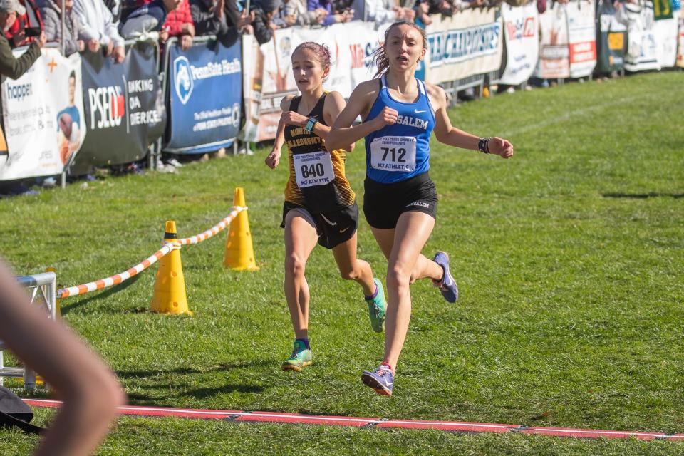 North Allegheny's Eva Kynaston (640) and Bensalem's Shana Kearney cross the finish line at the Class 3A girls' race during the PIAA cross country championships, Saturday, Nov. 6, 2021, in Hershey.