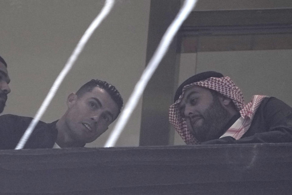 Al Nassr's Cristiano Ronaldo watches the Riyadh Season Cup soccer match between Inter Miami and Al Nassr at Kingdom Arena Stadium in Riyadh, Saudi Arabia, Thursday, Feb. 1, 2024. (AP Photo/Amr Nabil)