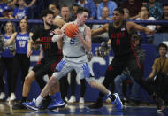 Air Force guard Chris Joyce, front, looks to drive to the basket as San Diego State guard Jordan Schakel, back left, and forward Matt Mitchell defend in the second half of an NCAA college basketball game Saturday, Feb. 8, 2020, at Air Force Academy, Colo. (AP Photo/David Zalubowski)