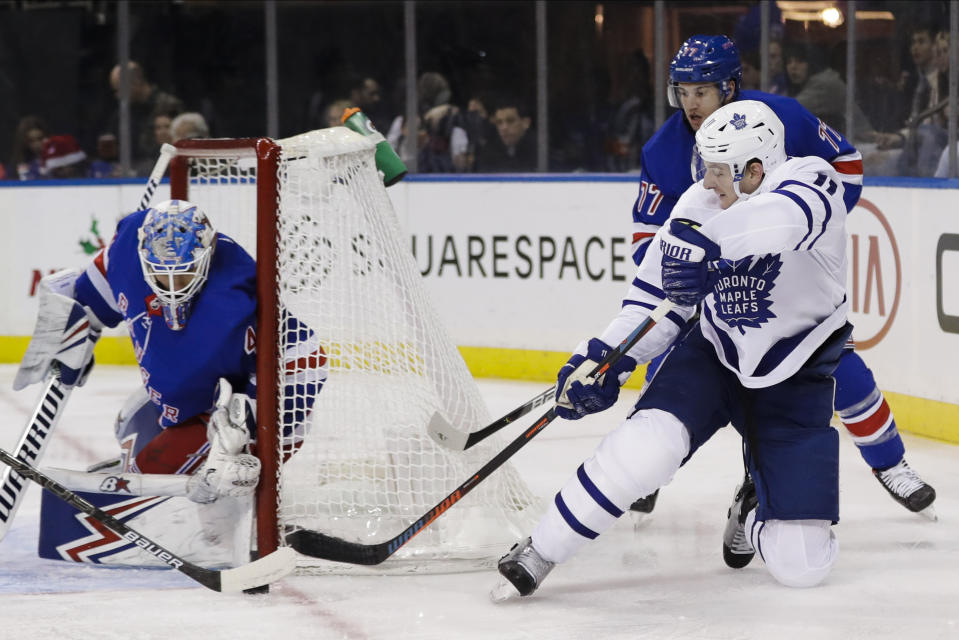 Toronto Maple Leafs' Zach Hyman, right, attempt to score as New York Rangers goaltender Alexandar Georgiev defends the net during the first period of an NHL hockey game Friday, Dec. 20, 2019, in New York. (AP Photo/Frank Franklin II)