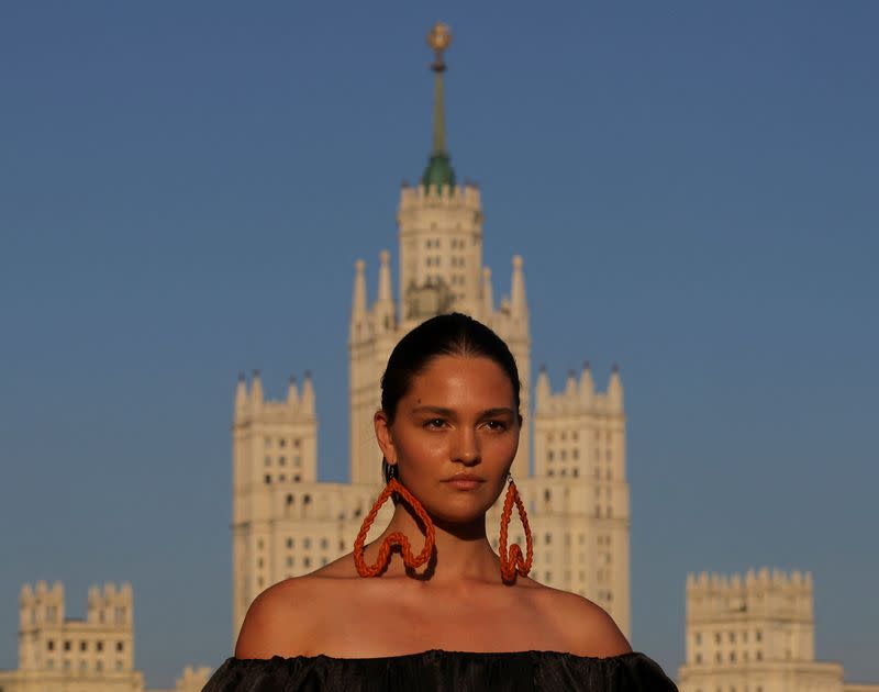 FILE PHOTO: Models present creations by Russian design house ALENA AKHMADULLINA at the embankment of Moskva river in Moscow