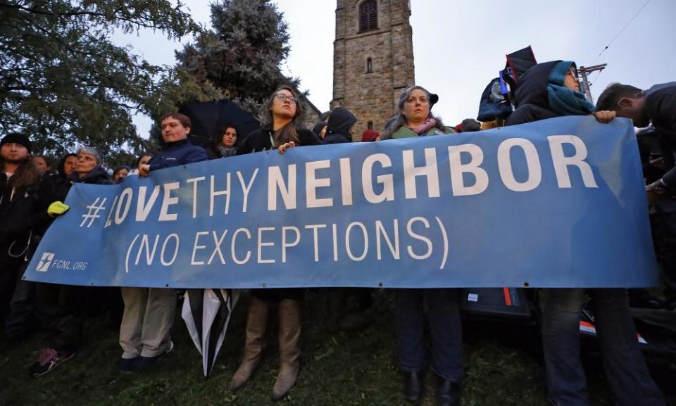 A group holds a vigil for the victims of the shooting at the Tree of Life synagogue where 11 people were killed.