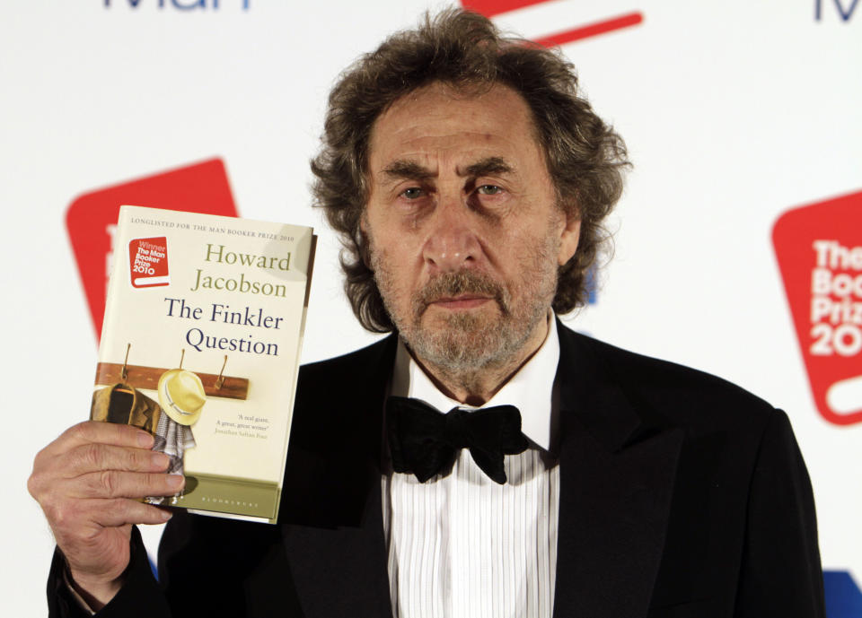 FILE - In this Oct. 12, 2010 file photo, British author Howard Jacobson displays his book "The Finkler Question", winner of the Man Booker Prize for Fiction 2010, following the announcement at central London's Guildhall, Britain. The Dalai Lama is set to headline India's Jaipur Literature Festival to speak about faith with one of his biographers, Pico Iyer. This year's festival will also feature author Zoe Heller and Booker Prize winner Howard Jacobson. (AP Photo/Lefteris Pitarakis, File)