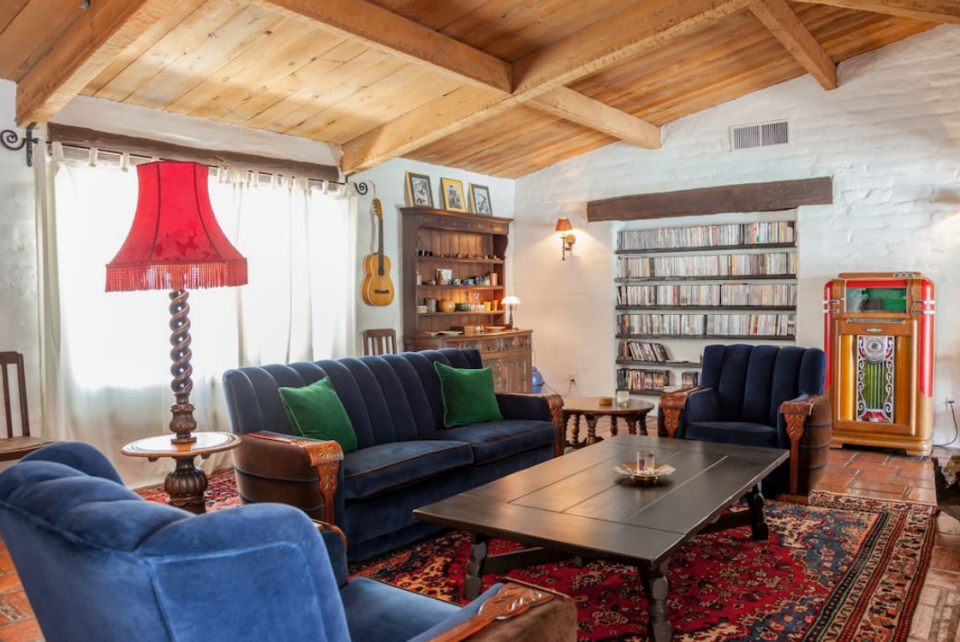 <p>The living room boasts beautiful wood-beamed ceilings, an exposed brick wall and a fireplace. (Airbnb) </p>