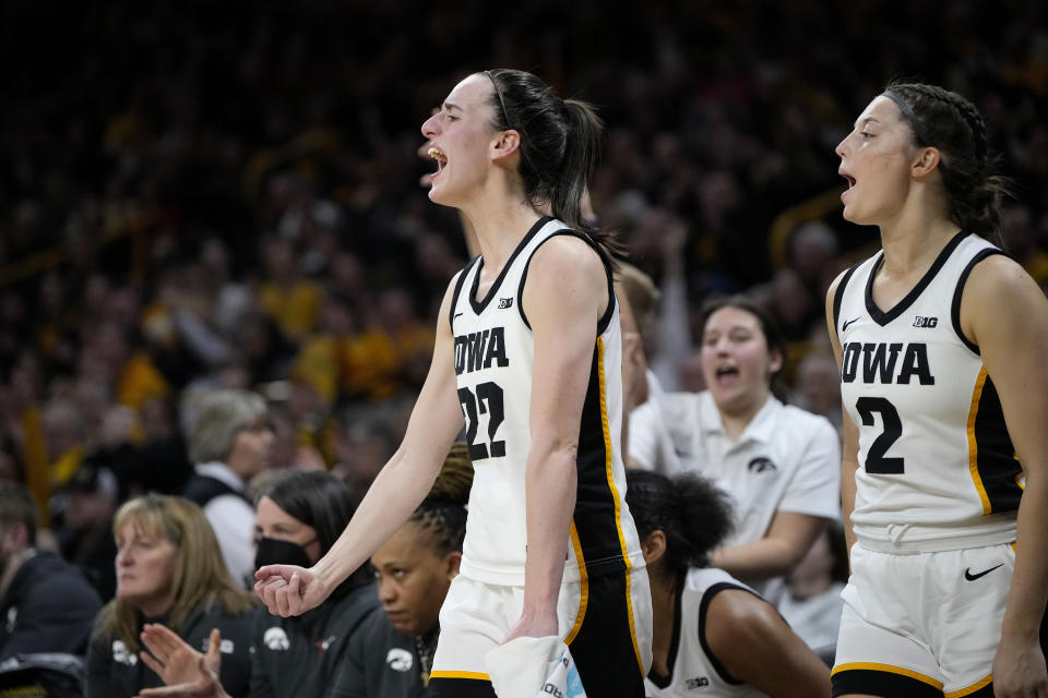 Iowa guards Caitlin Clark (22) and Taylor McCabe (2) celebrates a 3-pointer by guard Kate Martin during the second half of the team's NCAA college basketball game against Michigan, Thursday, Feb. 15, 2024, in Iowa City, Iowa. (AP Photo/Matthew Putney)