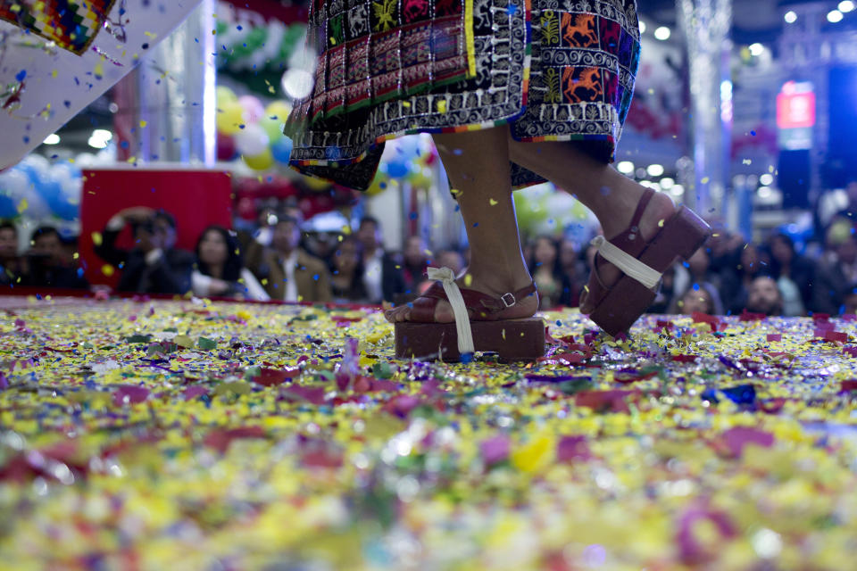 A contestant performs in wooden Pujllay dance shoes known as "ojotas", in a contest to elect the Queen of Great Power, in La Paz, Bolivia, Friday, May 24, 2019. The largest religious festival in the Andes choses its queen in a tight contest to head the Festival of the Lord Jesus of the Great Power, mobilizing thousands of dancers and more than 4,000 musicians into the streets of La Paz. (AP Photo/Juan Karita)