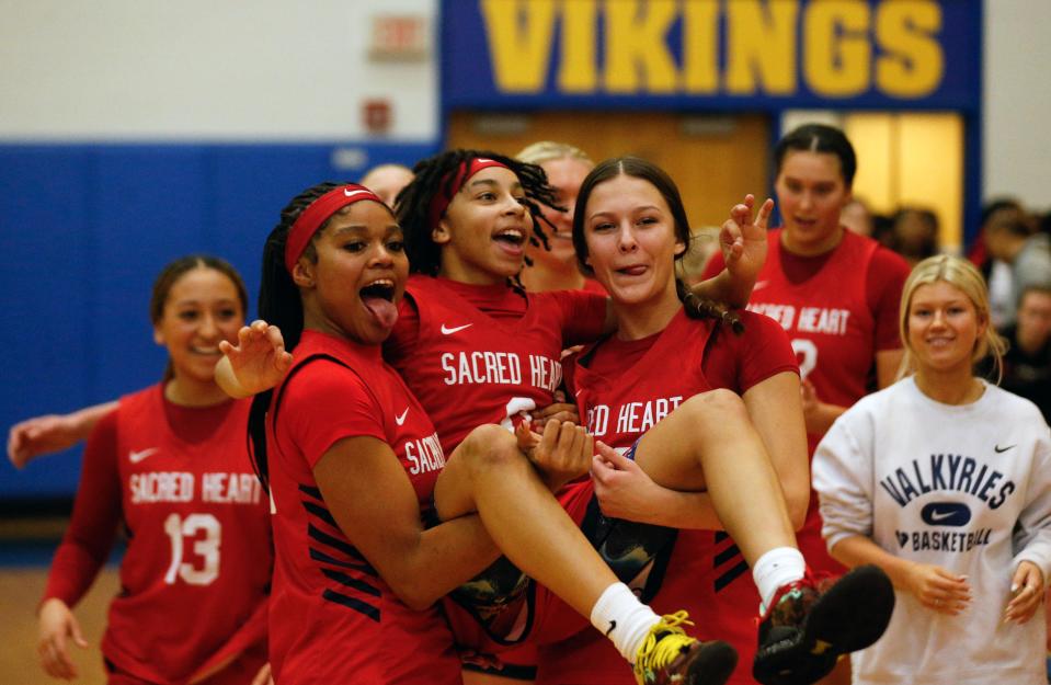Sacred Heart celebrates winning the Seventh Region Tournament for the fifth consecutive year.