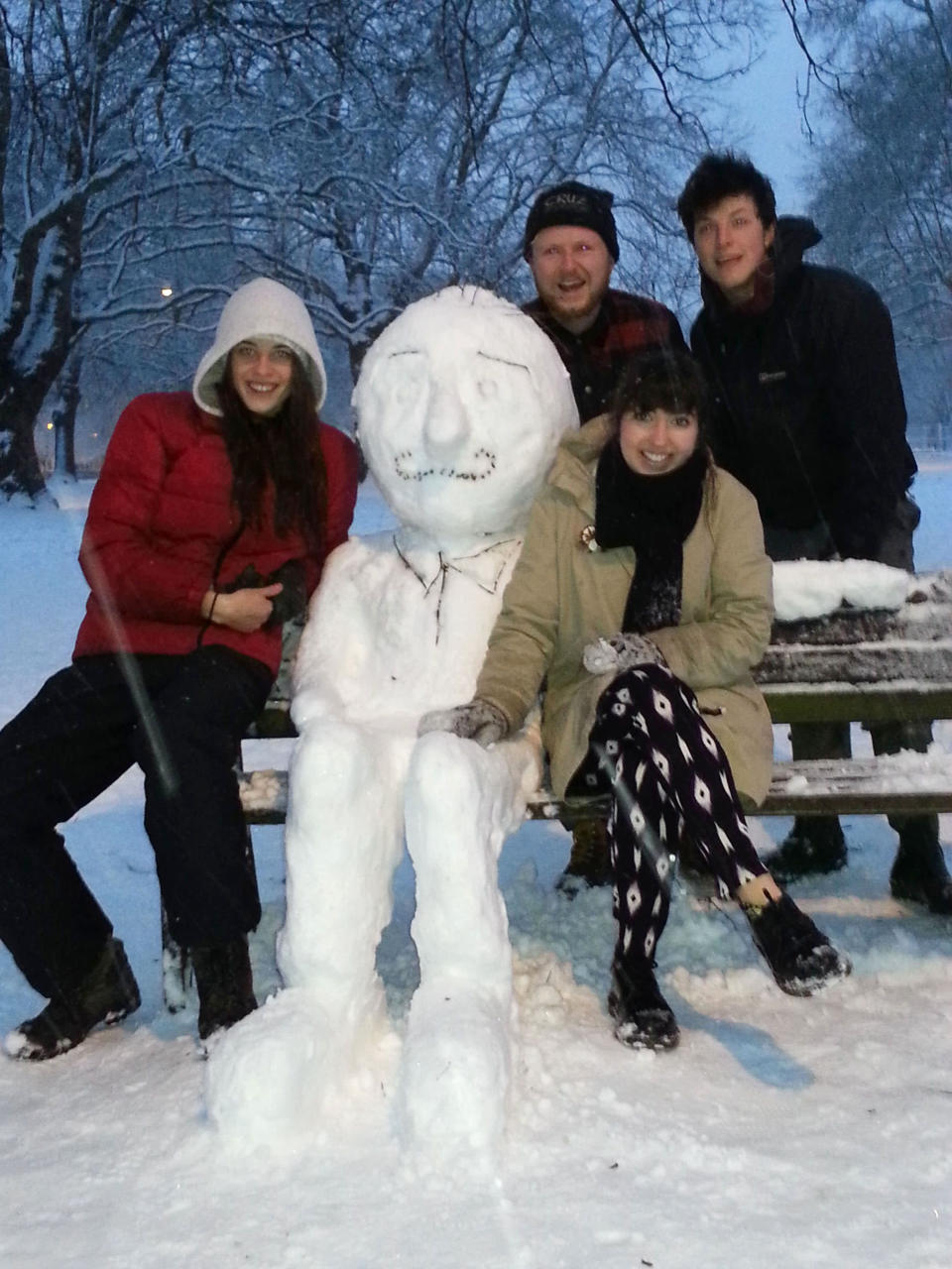 A group of friends with their snowman in London Fields, London (Nick Cunard/Rex Features)