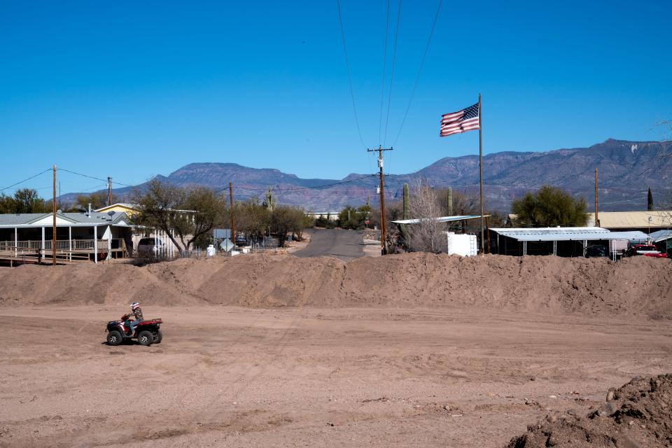 A four-wheeler drives down the wash, February 4, 2022, in Roosevelt, Arizona.