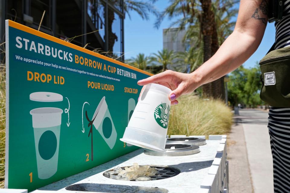 A reusable cup is returned to a borrow a cup return bin at an Arizona State University Starbucks shop in Tempe, Arizona. At the Arizona State store, if customers don't bring their own cup, they are given a reusable plastic one with a Starbucks logo. If they bring it back, they get $1 off, just like customers who bring their own.